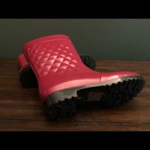 Pink rain boots with a pink umbrella